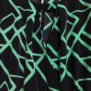 NWOT! Long sleeve dark blue and green romper with geometric pattern.